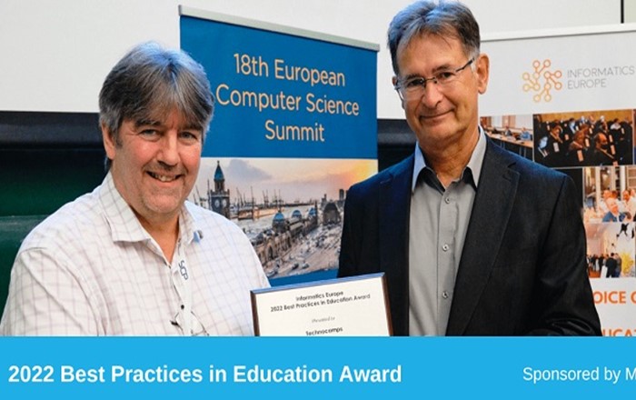 Professor Faron Moller, left, director of Technocamps, receives the award for best practice in education