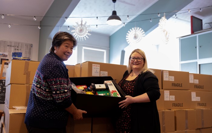 Audrey Reeve and Sarah Clifford holding one of the food hampers