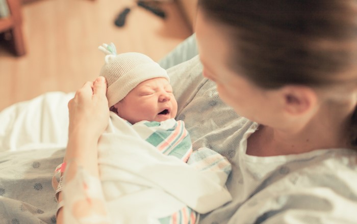 Mother holding a new born baby in her arms