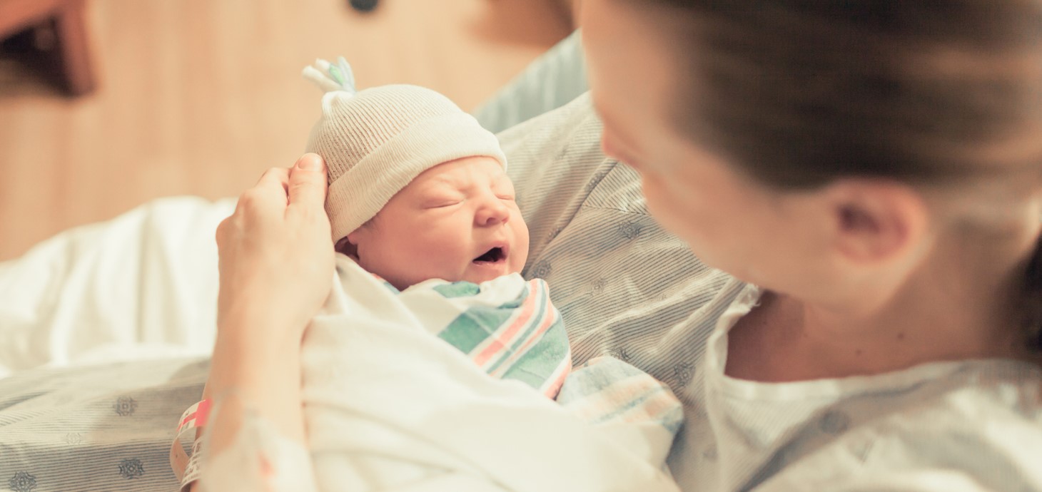 Mother holding a new born baby in her arms