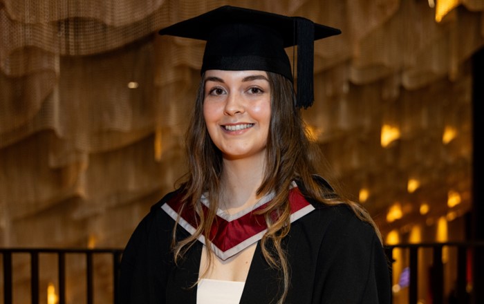 Éire in her cap and gown at graduation.