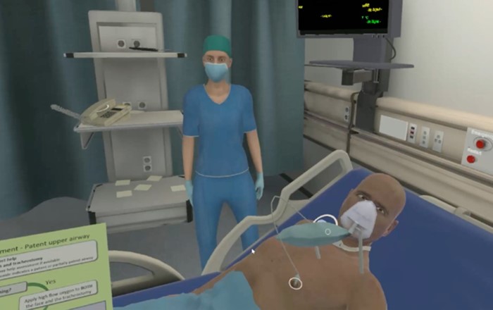 Virtual reality image of healthcare professional with a patient lying in a hospital bed.