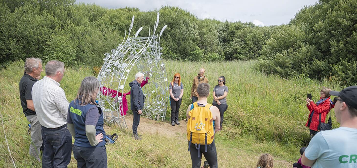 The new sculpture with a ribbon tied around it.