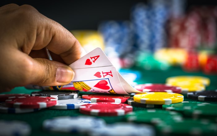 A close up of a person playing a card game. Credit: iStock.com/okan akdeniz