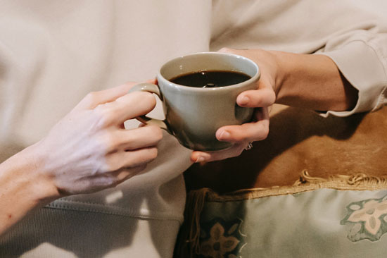 A woman and man sitting drinking a coffee