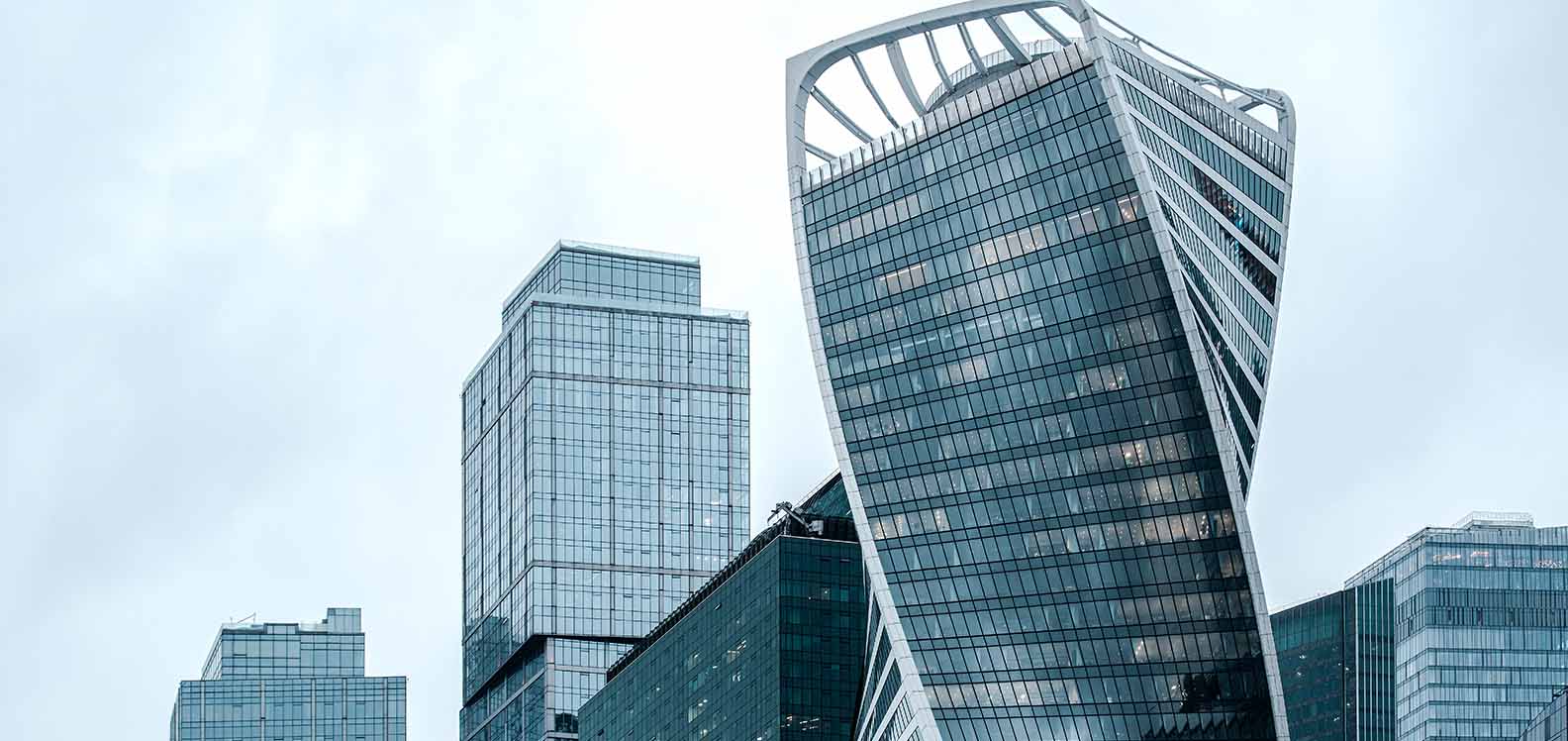 A complex of high-rise glass-fronted office buildings.