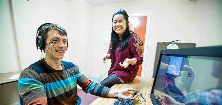 student sitting at computer in open access computer lab