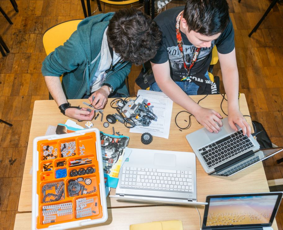 Young people use a computer to control a model