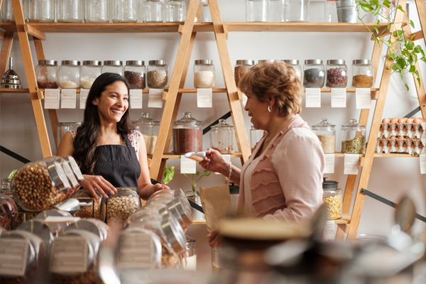 Women buying food from a low waste shop