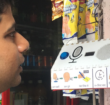 Man interacting with a Google speaker