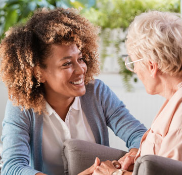 Woman speaking to an elderly woman