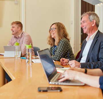 image of people talking around a table