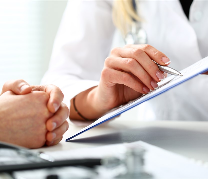 Researchers showing another researcher a document on clip board