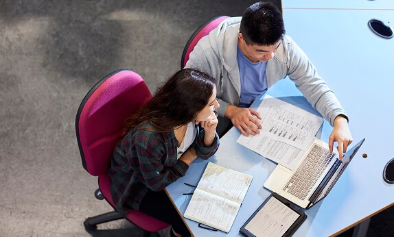 Students having a discussion in the library