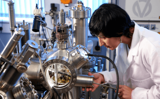 Woman in lab using mass spectrometer 