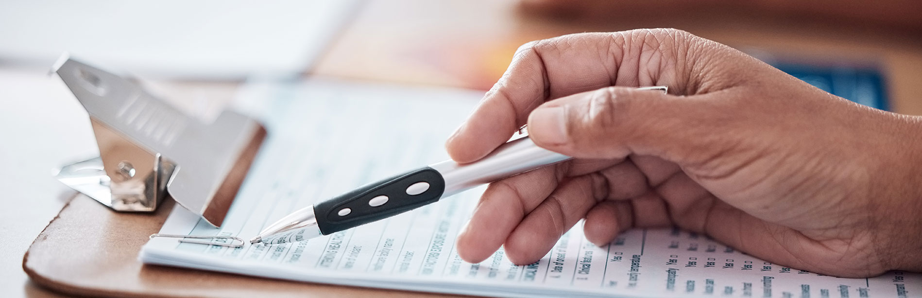 hand holding a pen running through a checklist