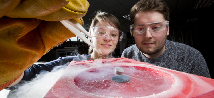 Physics students conducting experiment 