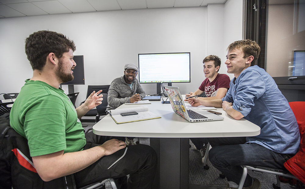 students discussing project around a table