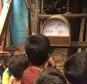 Children interacting with a Google speaker