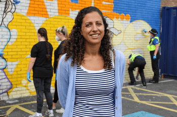 Academic in front of graffiti wall