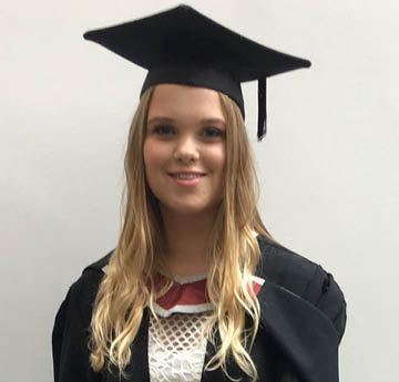 female in graduation cap and gown