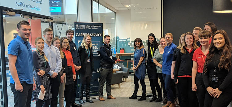 group of people smiling at the launch of an event