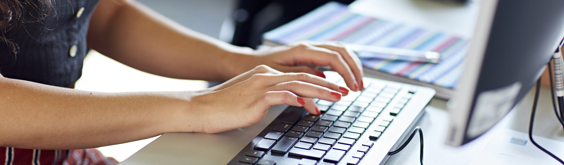 Working on a computer, typing on a keyboard