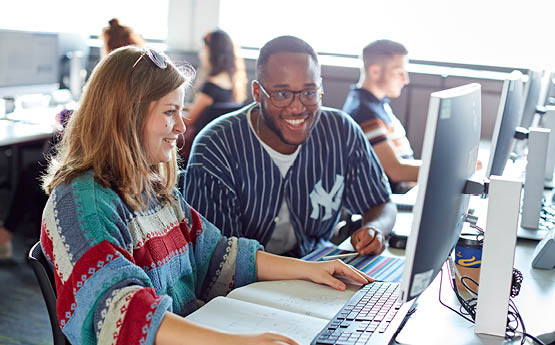 Students looking at a computer