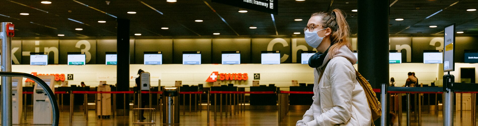 Woman wearing facemask in empty airport