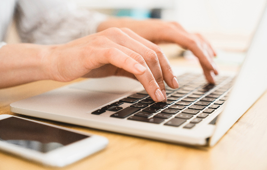 person typing on keyboard