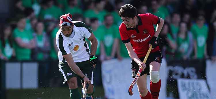 Swansea University mens hockey player takes on Cardiff University player during Wales Varsity match