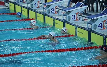 An image of Swansea University economics and finance undergraduate and swimming scholar Nathan Chan in the pool ready for a race.