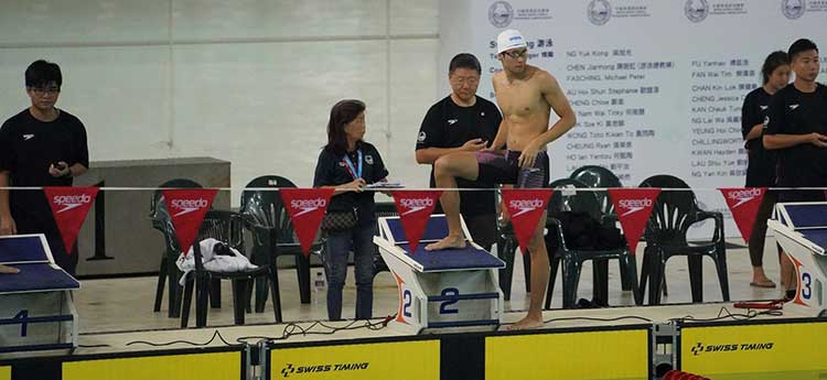 An image of Swansea University economics and finance undergraduate and swimming scholar Nathan Chan at poolside getting ready for swimming heat