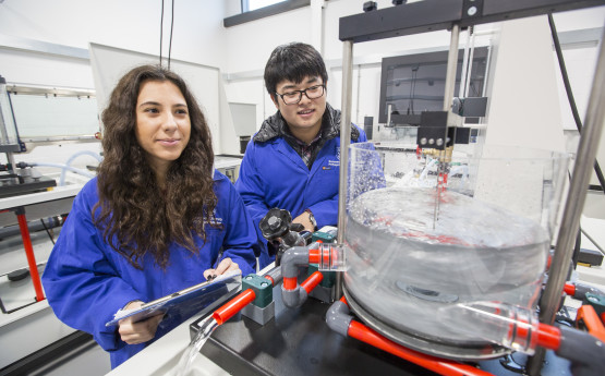 Students in blue lab coats 