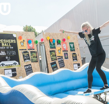 Female student on surf simulator board