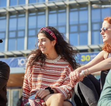 Female student smiling on Fulton lawn