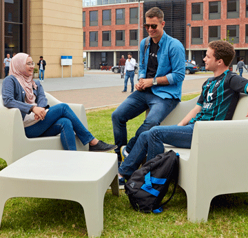 Students sat on chairs outside on Bay Campus