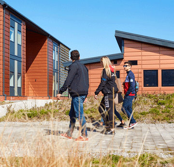 Students walking through Bay Campus in the sun