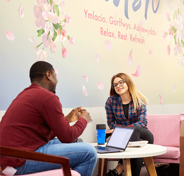 Two students sat in the Cwtsh study space