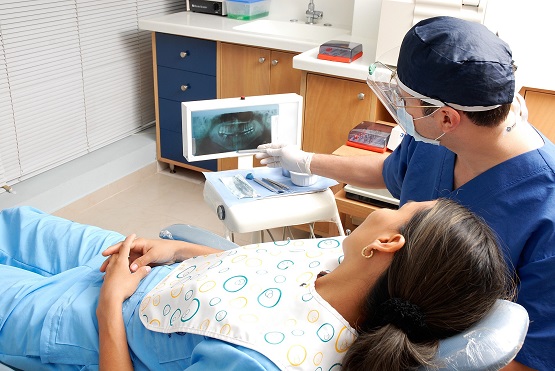 dentist and patient looking at x-ray