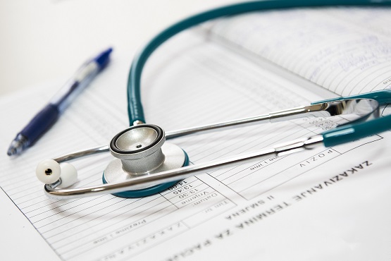 a doctor's stethoscope on top of an appointment book