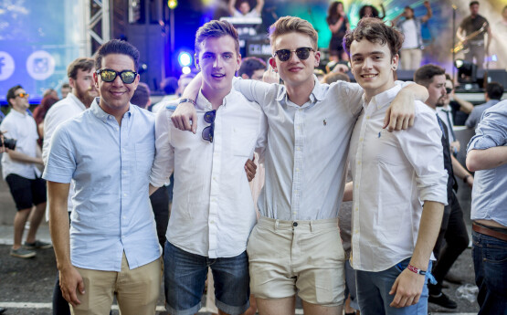 four male sudents in front of a stage