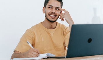 A male student thinking of what to write next