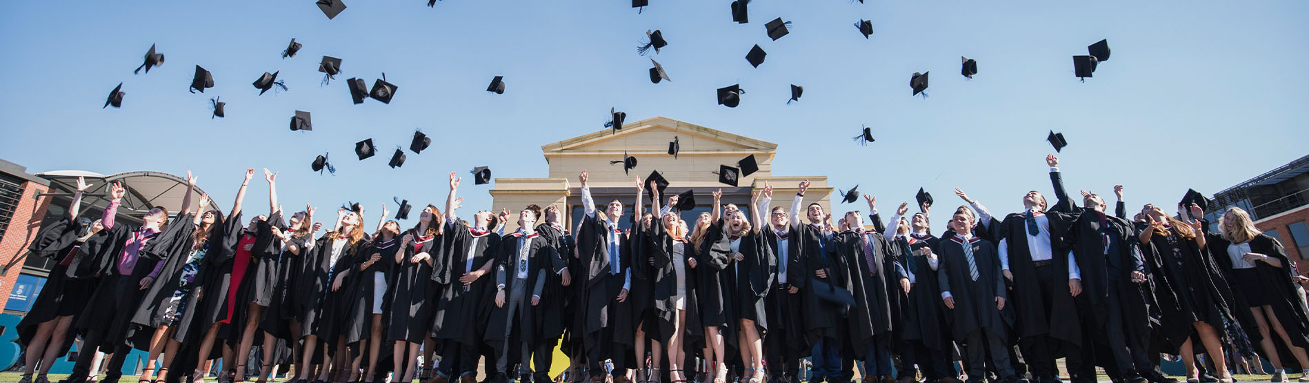 Students throwing caps into the air