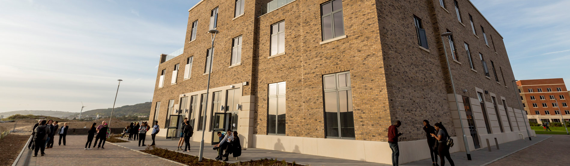 Students and staff outside the rear of The College academic building.