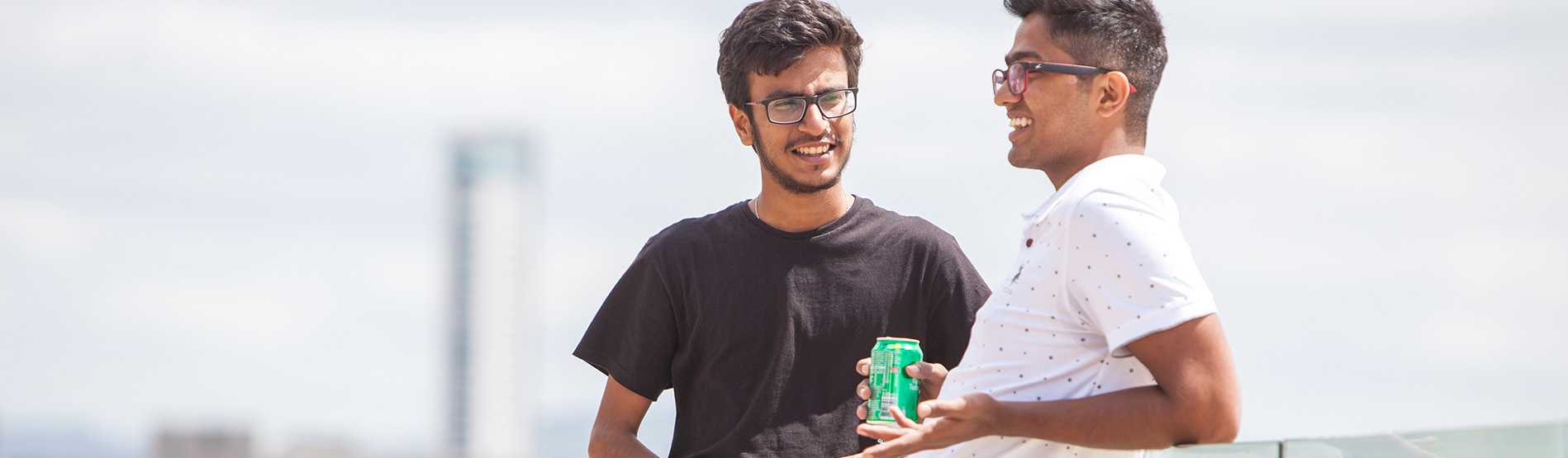 Two international students enjoying the beach and talking.