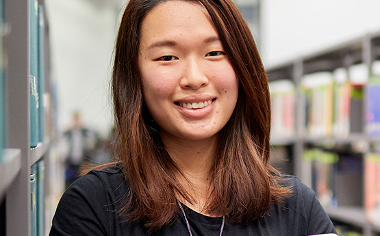 Student smiling with books.