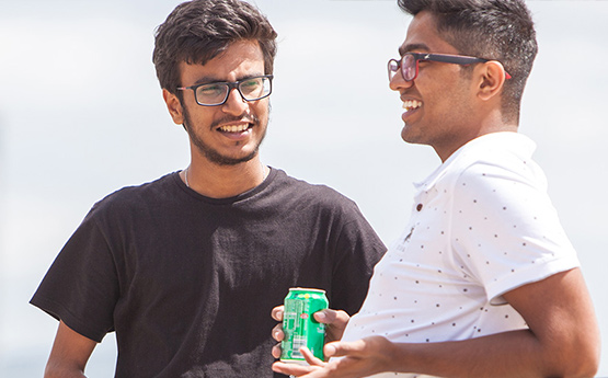 Students smiling on the seafront.