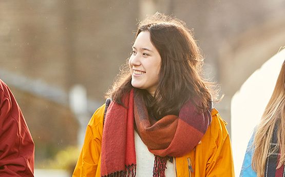 Student smiling outside in the sun.