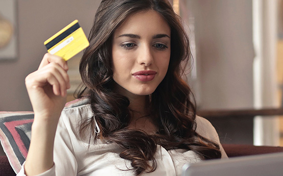 Student with credit card and laptop.